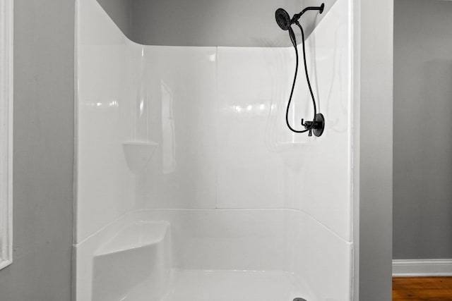 bathroom featuring wood-type flooring and walk in shower