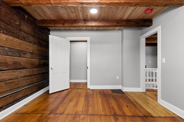 unfurnished bedroom with hardwood / wood-style floors, wood ceiling, and beam ceiling