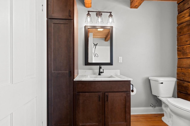 bathroom with hardwood / wood-style flooring, vanity, and toilet