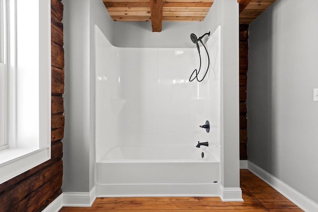 bathroom featuring shower / bathtub combination, wood-type flooring, beam ceiling, and wooden ceiling