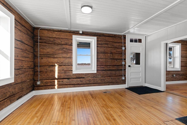 entrance foyer featuring a healthy amount of sunlight, hardwood / wood-style floors, and wood ceiling