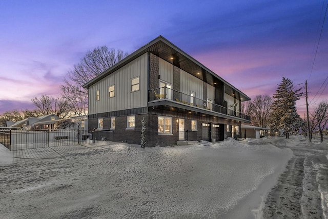 property exterior at dusk with a balcony