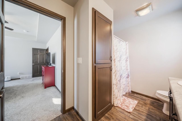 bathroom with vanity, hardwood / wood-style floors, and toilet