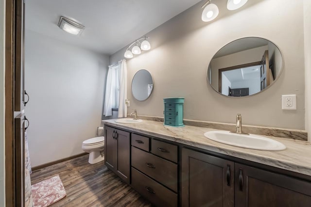 bathroom featuring vanity, toilet, and hardwood / wood-style floors