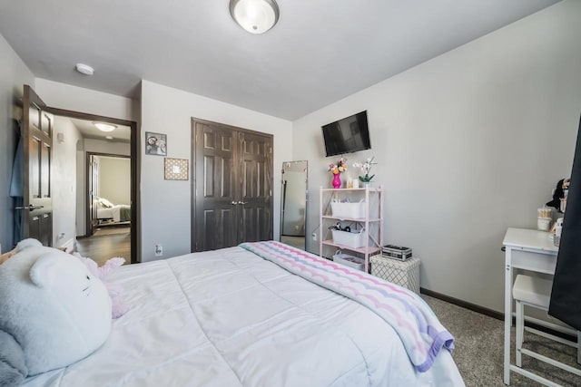 bedroom with dark carpet and a closet