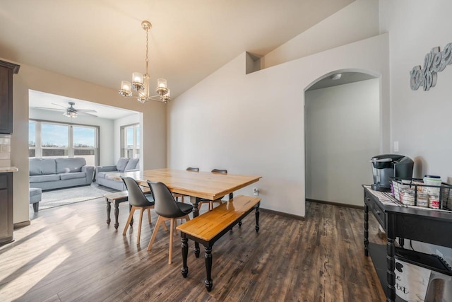 dining room with lofted ceiling, a notable chandelier, and dark hardwood / wood-style flooring