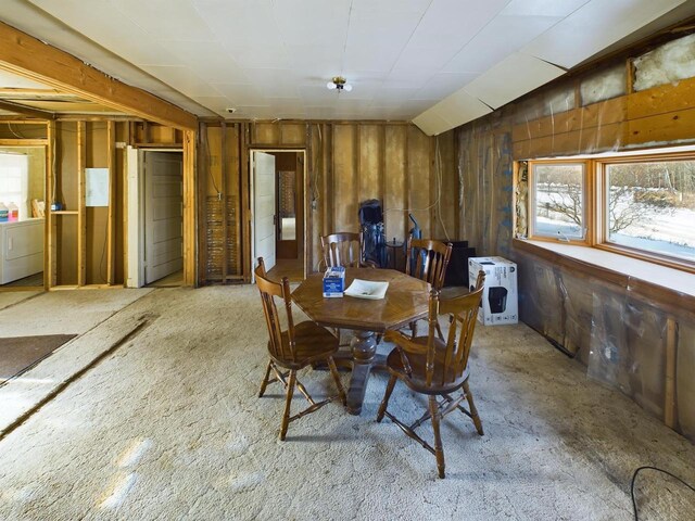 3675 Flanner Ln, Laona, WI 54541 - dining area featuring vaulted ceiling, wooden walls, and independent washer and dryer