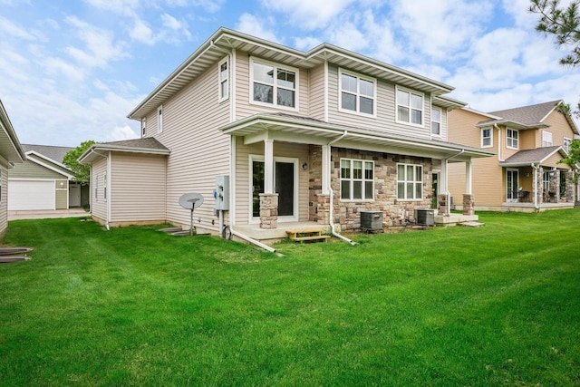 back of house featuring central AC unit and a lawn