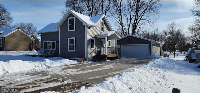 view of front of property with a garage and an outdoor structure