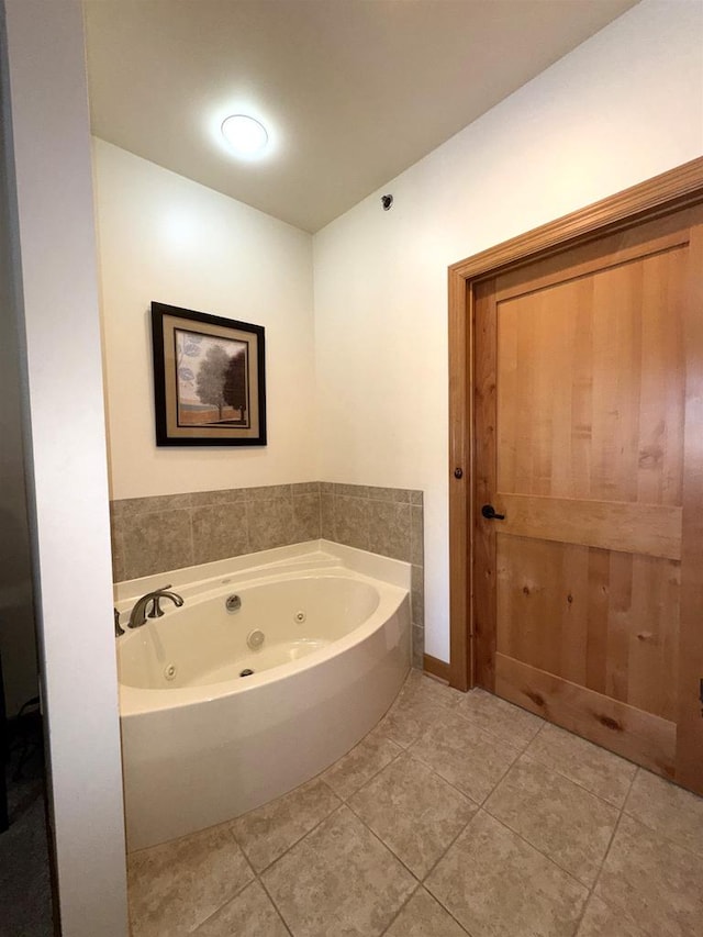 bathroom featuring a bath and tile patterned flooring