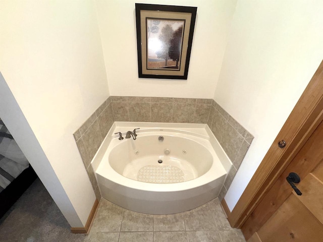 bathroom with tile patterned flooring and a washtub