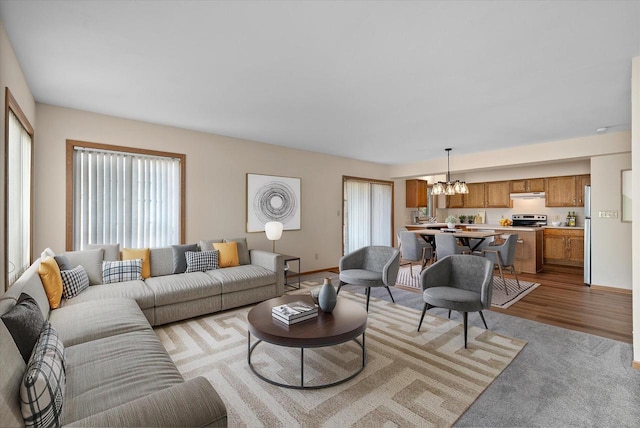 living room featuring a chandelier and light hardwood / wood-style flooring