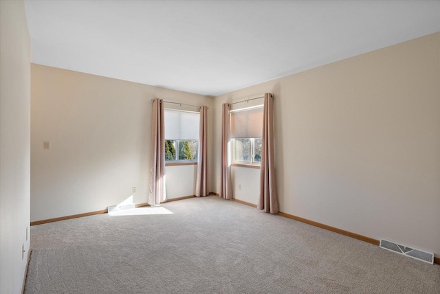 empty room featuring light colored carpet