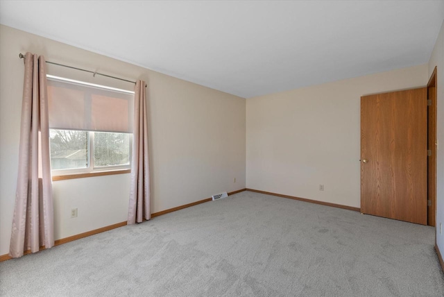 spare room with light colored carpet