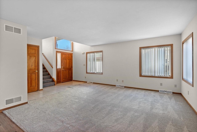 spare room with light colored carpet