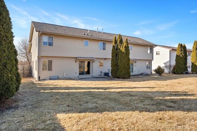 rear view of house featuring a yard, a patio, and central air condition unit