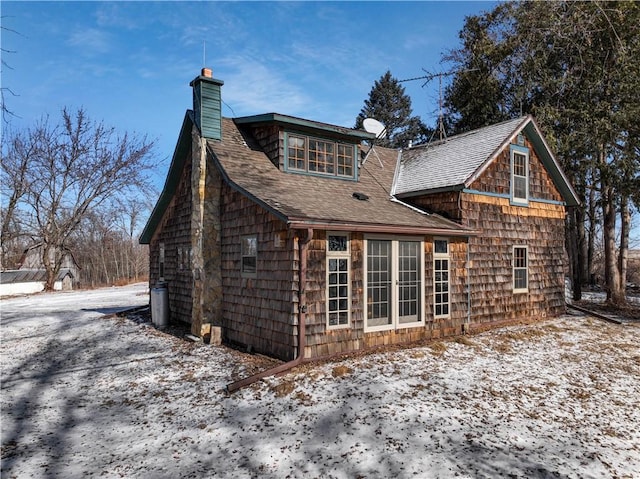 view of snow covered back of property