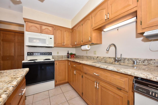 kitchen featuring sink, electric range oven, light tile patterned floors, dishwashing machine, and light stone countertops