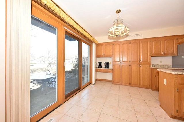 kitchen with pendant lighting and light tile patterned floors