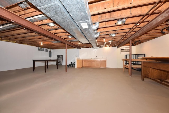 basement featuring bar and electric panel