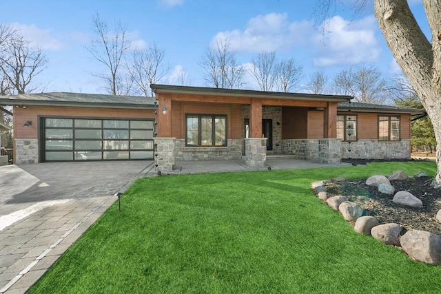 view of front of property with a garage and a front lawn