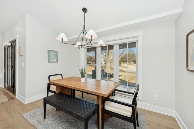 dining area featuring a chandelier and light hardwood / wood-style flooring