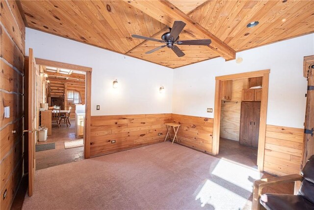 15035W Goss Rd, Hayward, WI 54843 - carpeted empty room with wood ceiling, beamed ceiling, ceiling fan, and wood walls