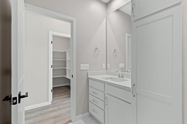 bathroom with vanity and hardwood / wood-style floors