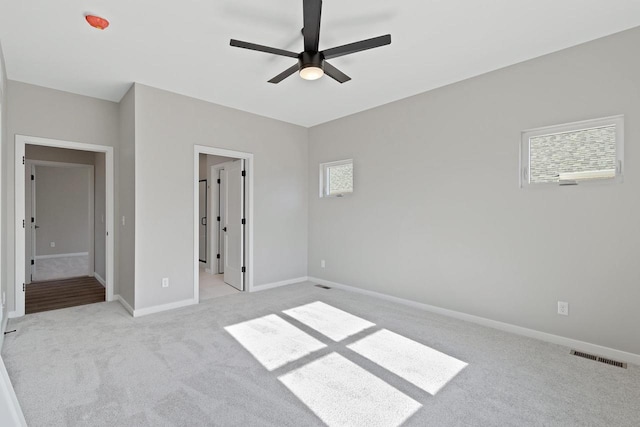 unfurnished bedroom with light carpet and ceiling fan