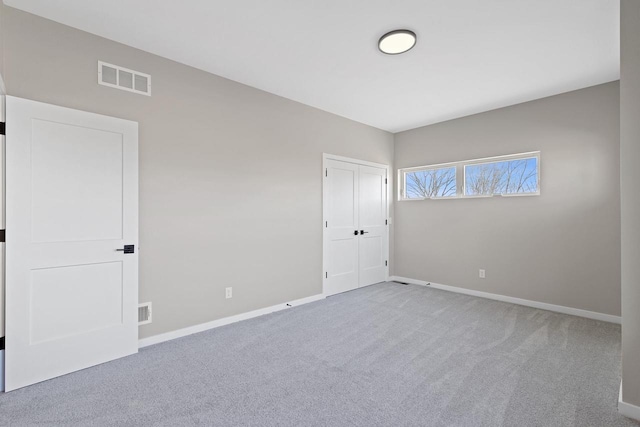 unfurnished room with light carpet