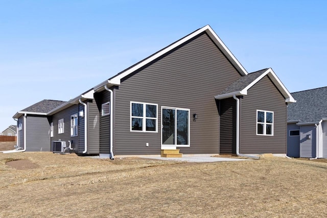 rear view of property with cooling unit