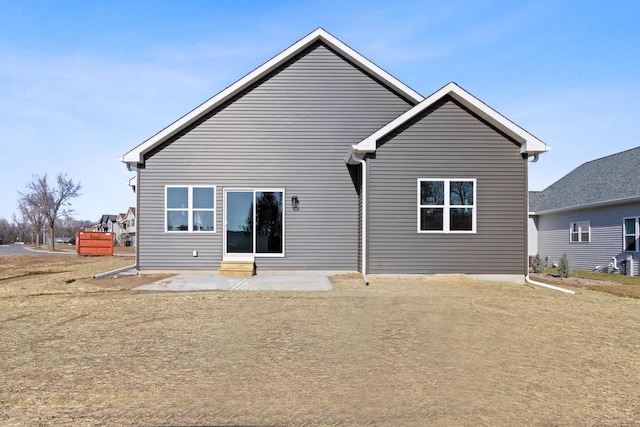 rear view of property with a patio and a yard