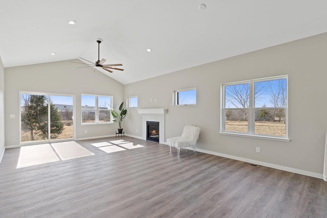 unfurnished living room featuring high vaulted ceiling, ceiling fan, and light hardwood / wood-style flooring