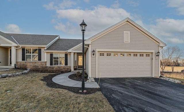 view of front of house featuring a garage and a front lawn