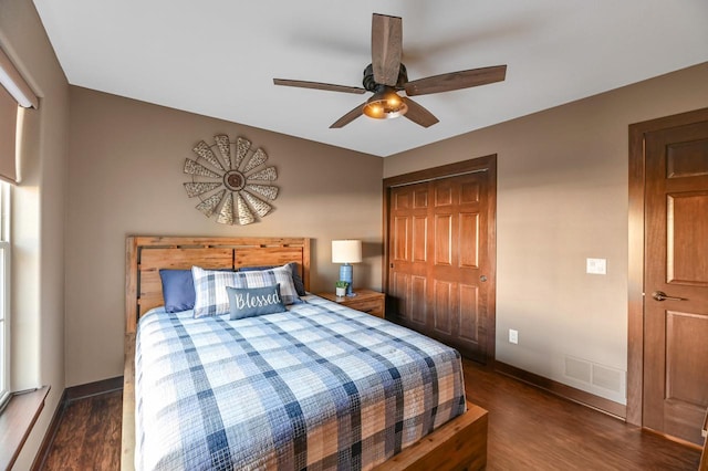 bedroom with ceiling fan, dark hardwood / wood-style flooring, and a closet