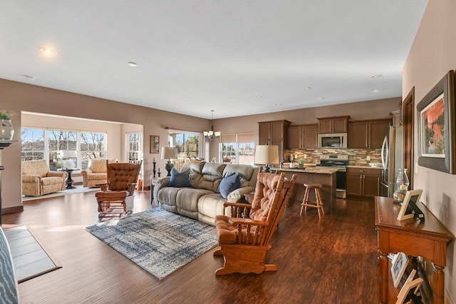 living room featuring dark hardwood / wood-style floors and a chandelier