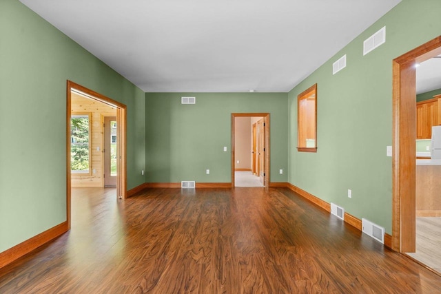 empty room with dark wood-type flooring