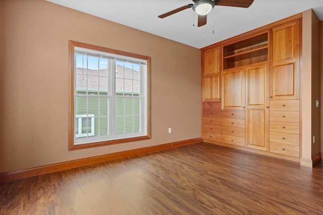 unfurnished bedroom featuring ceiling fan and dark hardwood / wood-style flooring