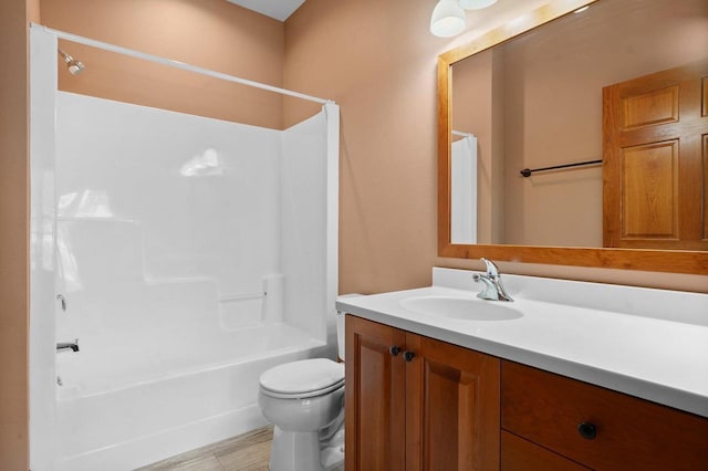 full bathroom featuring shower / bathtub combination, vanity, and toilet