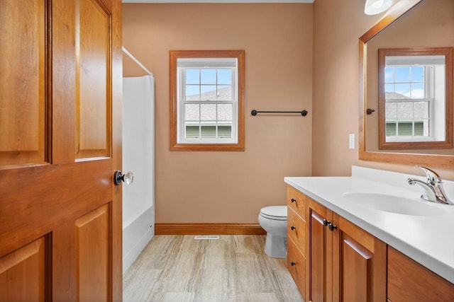 bathroom featuring vanity, toilet, and hardwood / wood-style floors