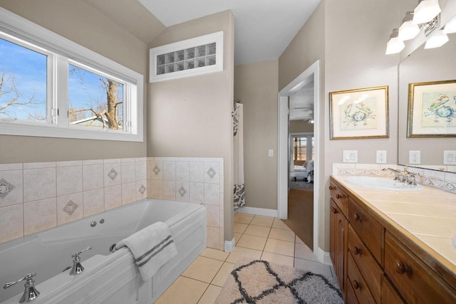 bathroom with vanity, a washtub, and tile patterned floors