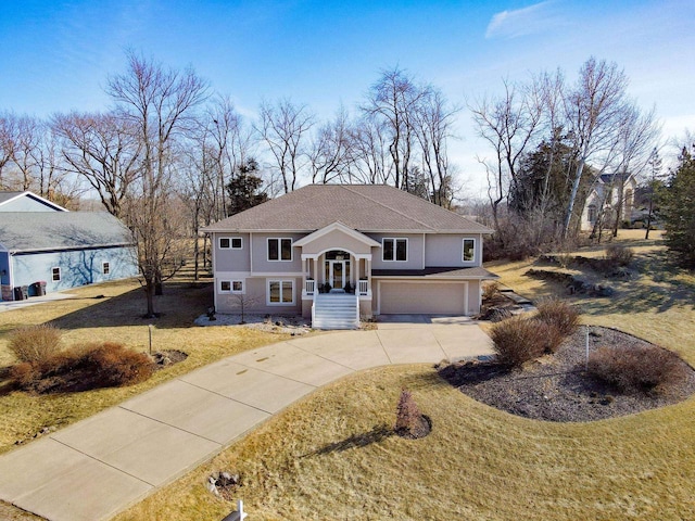 bi-level home featuring a garage and a front yard