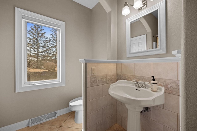 bathroom with tile patterned floors and toilet