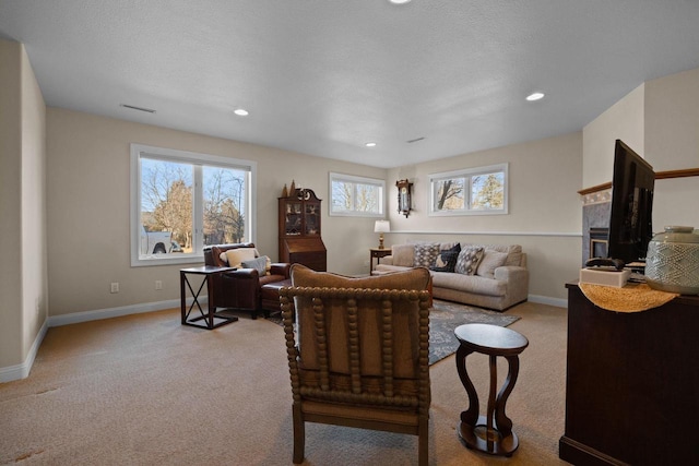 living room featuring light colored carpet and a textured ceiling