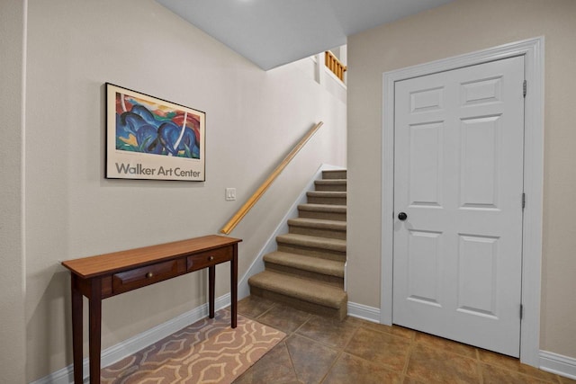 staircase with tile patterned floors