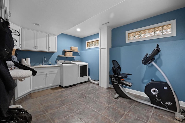 laundry area with sink, tile patterned floors, cabinets, and independent washer and dryer