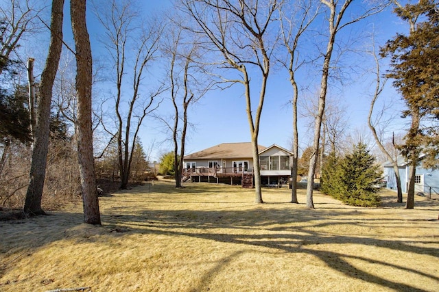 view of front of property featuring a deck and a front lawn