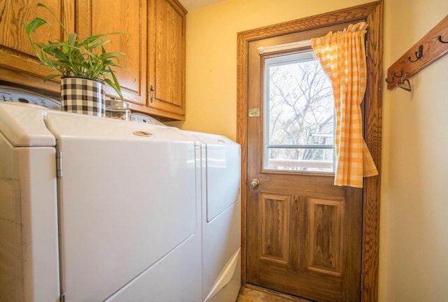 laundry room featuring cabinets and washing machine and dryer