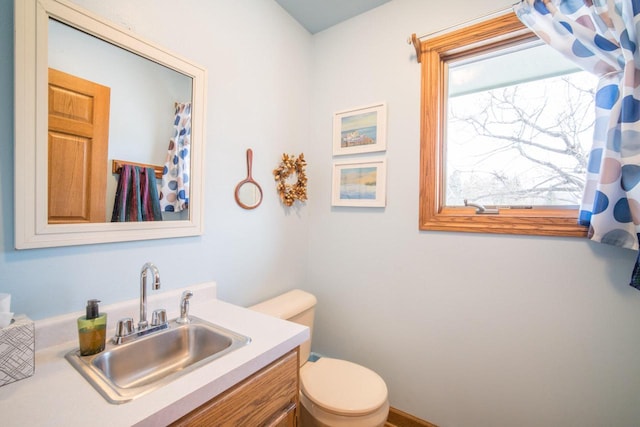 bathroom featuring vanity and toilet