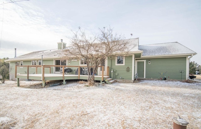 rear view of house featuring a wooden deck